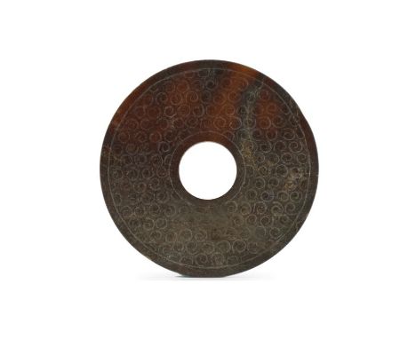 A Chinese dark russet jade disc, Bi Warring States The opaque dark reddish-brown stone with darker brown inclusions of even t