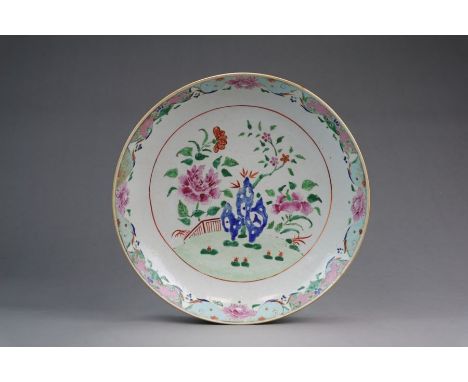 A large Chinese famille rose dish 18th Century Of shallow rounded form, painted in colours with flowering peonies and other p
