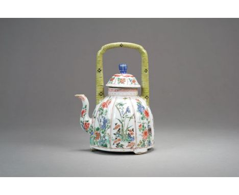 A Chinese famille verte teapot and cover18th/19th CenturyOf lobed bell form with domed cover and lotus finial, the loop handl