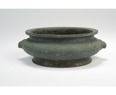 A Chinese bronze censer Possibly Xuande period Of compressed ovoid form, the flat everted rim with moulded edge line, the bod
