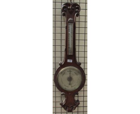 A carved oak cased Nagretti and Zambra barometer with a silvered dial
