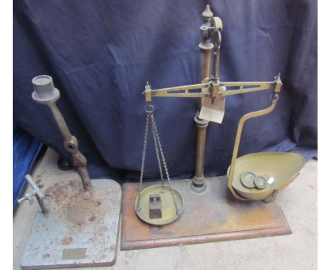 A brass balance scales with some weights together with a Dental press base