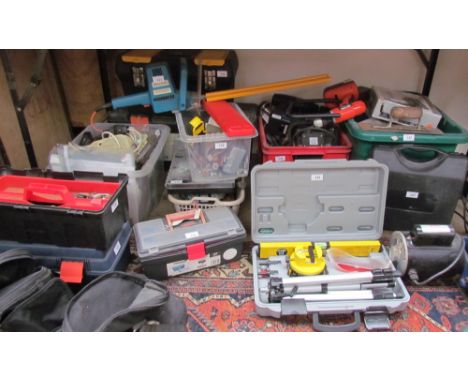 A laser level, cased together with a large quantity of tools