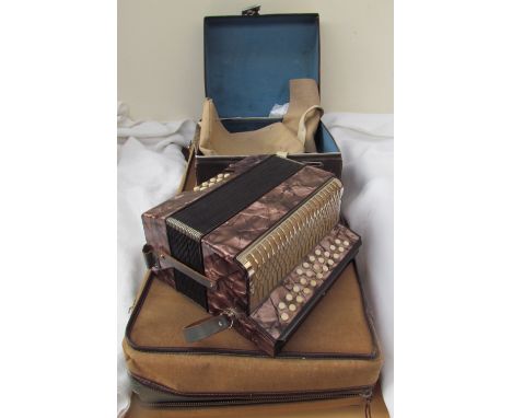 A Hohner Lilliput button accordion, cased together with a bassoon case 