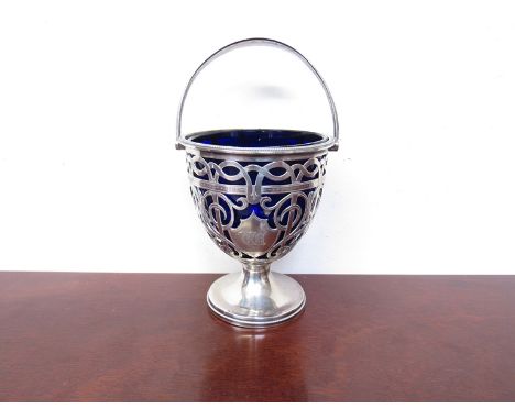 A Haseler Brothers silver pierced pedestal bon-bon bowl with blue glass liner and swing handle, monogrammed Chester 1906, 164