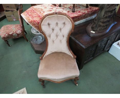 A Victorian walnut button back nursing chair
