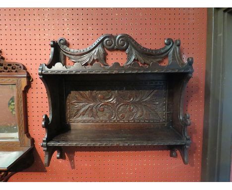 A Victorian oak carved wall shelf