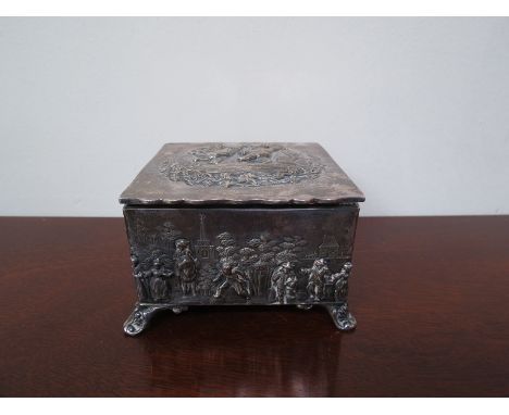 A Thomas Hayes silver jewellery casket with figures in high relief in vintage scenes, raised on four swept feet, Birmingham 1