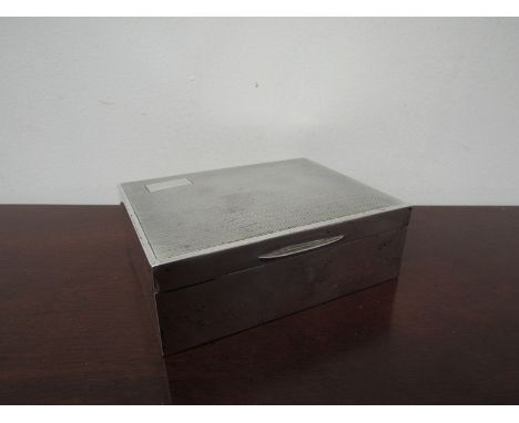 A silver A E Poston & Co Ltd cigarette  box with engine turned detail (slight dents), 12cm x 19cm 
