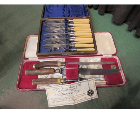 A John Turton horn handle carving set, cased and a fish knife and fork set, cased