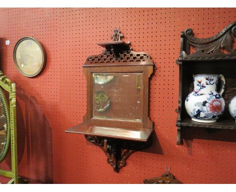 A circa 1900 mahogany fretwork wall mirror with shelf