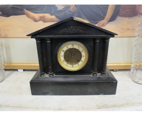 A late 19th Century black slate mantel clock of architectural form