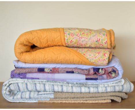 Three mid-to-late 20th century heavyweight quilted blankets. A quilted coverlet in taupe, having a central square bordered de
