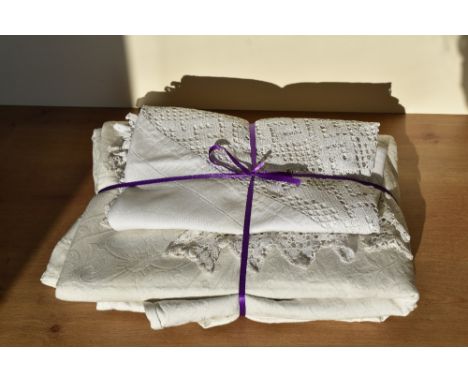 Two examples of 1980s white cotton textiles for the home. An embossed bedspread featuring a floral and foliate design with Gr