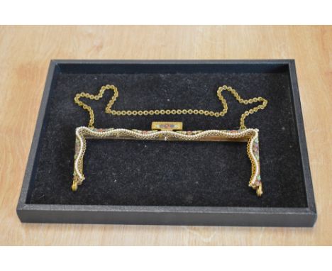 A vintage handbag frame, in brass with a wavy row of faux pearls, having floral detailing with red, blue, green and white ena