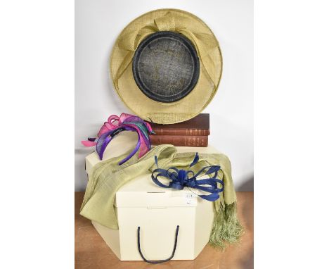 A collection of modern wedding accessories, comprising a wide Viyella hat in navy and neutral woven hat with large bow detail