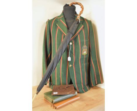 A collection of antique and vintage men's travel cases, accessories and a collegiate blazer. An antique blazer in racing gree