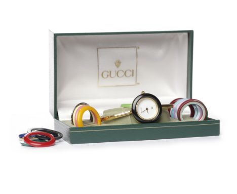 LADY'S GUCCI BANGLE QUARTZ WRIST WATCHthe round white dial lacking numerals, the 26mm case with Gucci logo and 11/12, 0797838