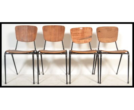 A set of four vintage early / mid 20th Century French Industrial stacking chairs raised on metal frames with ply backs and se