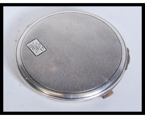 A vintage early 20th Century hallmarked silver compact of circular form having engine turned decoration. Weighs 53.5 grams gr