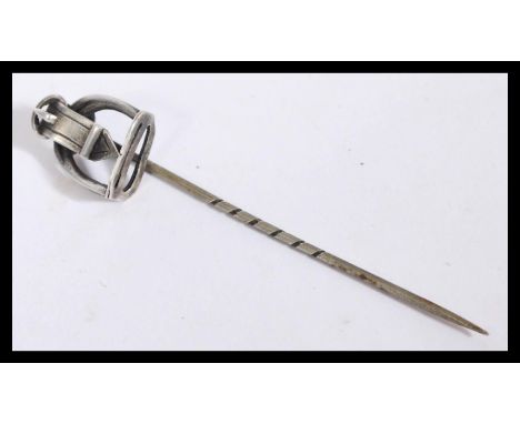 A silver white metal hat pin / tie pin of hunting interest, having a stirrup and buckle finial and a twisted pin.&nbsp;