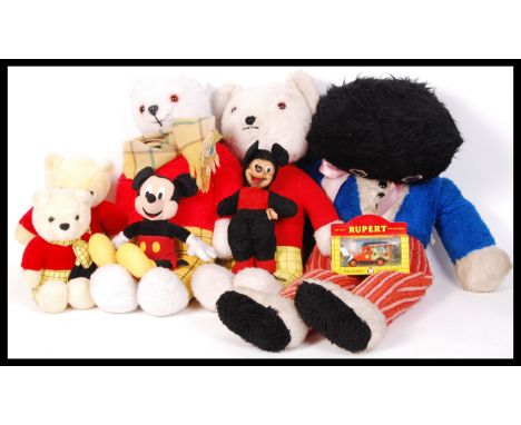 A collection of assorted vintage plush teddy bears and dolls to include; A large Chad Valley Robinson Golly, 4x Rupert Bears 