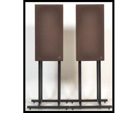 A pair of retro 20th Century Kef ebonised speakers together with a pair of tubular floor standing speaker stands.