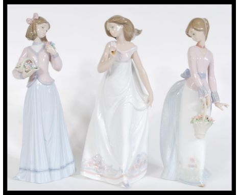 A set of three Lladro ceramic figurines comprising of Basket of Love 07622, Innocence in Bloom 07644 and Afternoon Promenade 