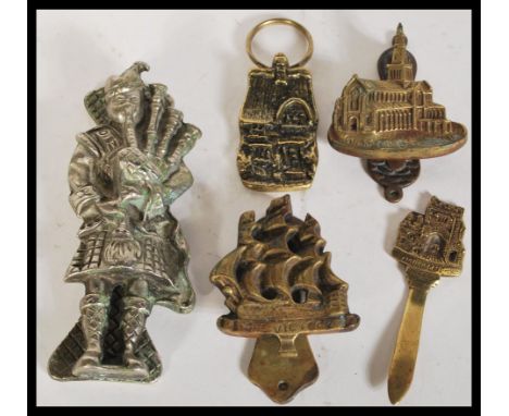 A group of 19th Century Victorian brass and other door furniture knockers comprising of Scottish Highlander playing bagpipes,