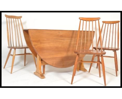 A set of three Ercol tall stick back dining chairs along with an Ercol Windsor pattern blonde beech and elm drop leaf dining 