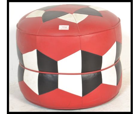 A retro mid century two tone vinyl panel stitched pouffe, having a geometric design to the top. Measures 40cm high x 45cm wid