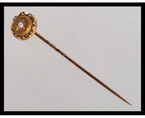 A hallmarked 15ct gold Victorian seed pearl stick pin. The pin tip to being adorned with a cluster of seed pearls. Measures 5