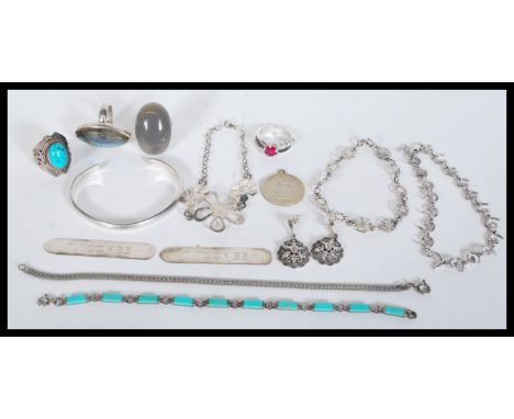 A selection of silver jewellery to include drop earrings, a labradorite ring, a turquoise stone ring, a grey stone ring, a sp