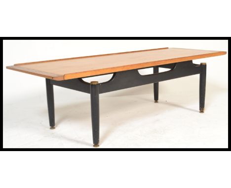 G Plan - A mid 20th Century vintage tola - teak wood top librenza pattern coffee table, the suspension teak top raised on an 