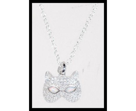 A sterling silver CZ and opal set necklace pendant in the form of a cat mask set to sterling silver chain. Weighs 5.2 grams.