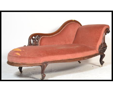A Victorian 19th century mahogany chaise longue having a scrolled show wood frame with white ceramic castors to the legs, arc