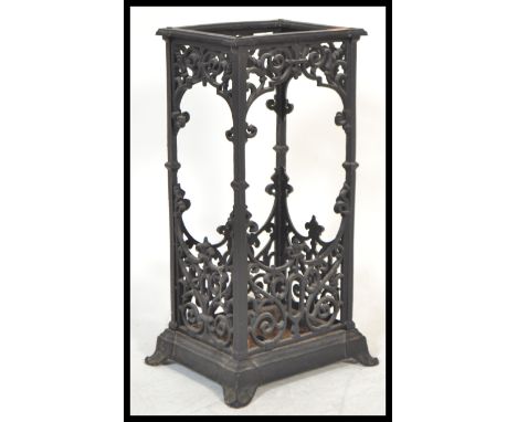 A 20th Century cast iron walking stick / umbrella stand raised on four feet having a rectangular base with pierced scrolled d