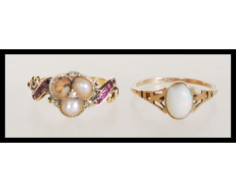 Two hallmarked gold rings to include a stamped 8ct gold ring set with an oval opal with pierced decoration shoulders (size N)