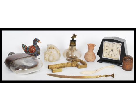 A group of vintage items to include an early 20th Century leather and glass hip hunting flask, an ebonised Art Deco mantel cl