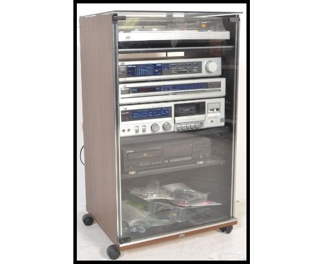 A retro JVC stacking music system to include record deck, cassette tape player, amplifier all within a JVC music cabinet.