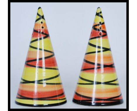 A pair of&nbsp; Crown Devon sugar shakers in the style of Clarice Cliff hand painted by Dorothy Ann in a yellow and red geome