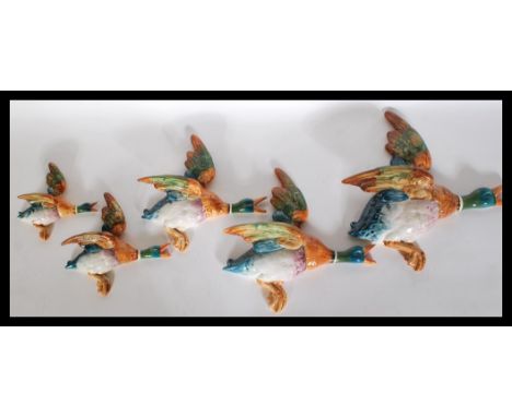 A set of five 1930's Art Deco Beswick graduating ceramic wall plaques in the form of flying ducks. Stamped Beswick to the bac