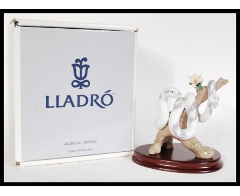 A Lladro Zodiac collection ceramic figurine entitled The Snake 6780. The Lladro figure modelled as a snake entwined around th