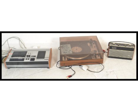 A vintage retro 20th Century Dual 601 two speed record player, smoked perspex lid,together with a Tandberg TCD 310 cassette p