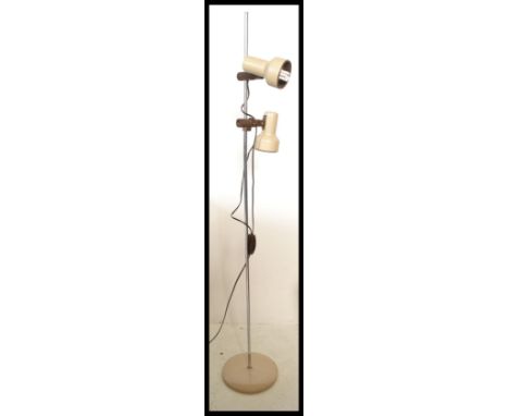 A vintage 1970's free standing adjustable floor lamp raised on a beige enamelled round base with a central chrome bar with tw