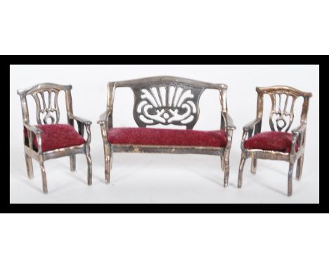 A 20th Century silver miniature doll's house Chippendale style salon suite set to include a sofa being open framed with pierc