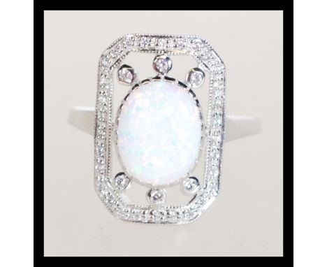 A sterling silver CZ dress ring having a central oval opal panel. Size O weighs 2.1 grams.