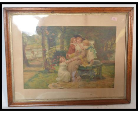 A late 19th Century walnut framed and glazed print depicting a mother and her children by the river in the manner of a pears 