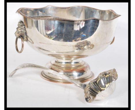 A large 20th Century silver plated punch bowl raised on circular foot with lion mask hoop handles. Complete with scalloped se