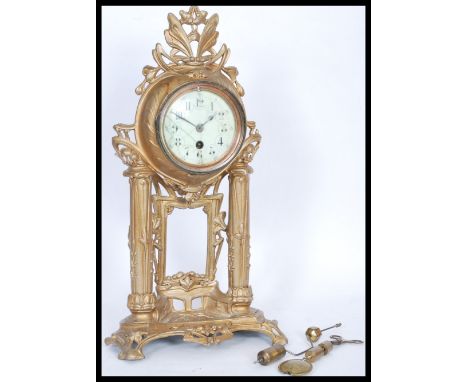 A 19th Century French ormolu gilt brass Portico clock having a white enamel face with detailed chapter ring and faceted hands